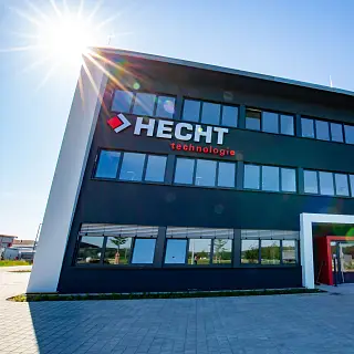 Firmengebäude von HECHT mit Firmenlogo an der Fassade